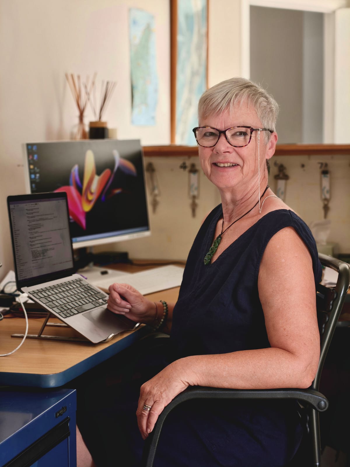 Sandi at her desk working with AI tools